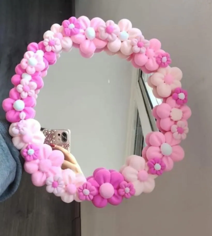 Round mirror covered in puffy pink clay blossoms